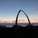 Whale bones arch in front of sunset.